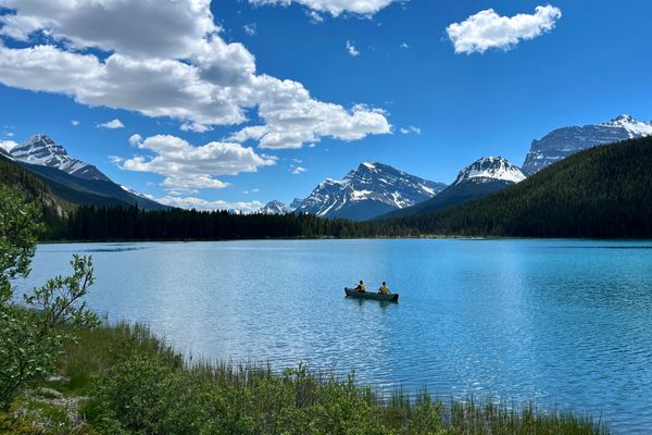 Canoeing on a glacial lake in the Canadian Rockies with a guide
