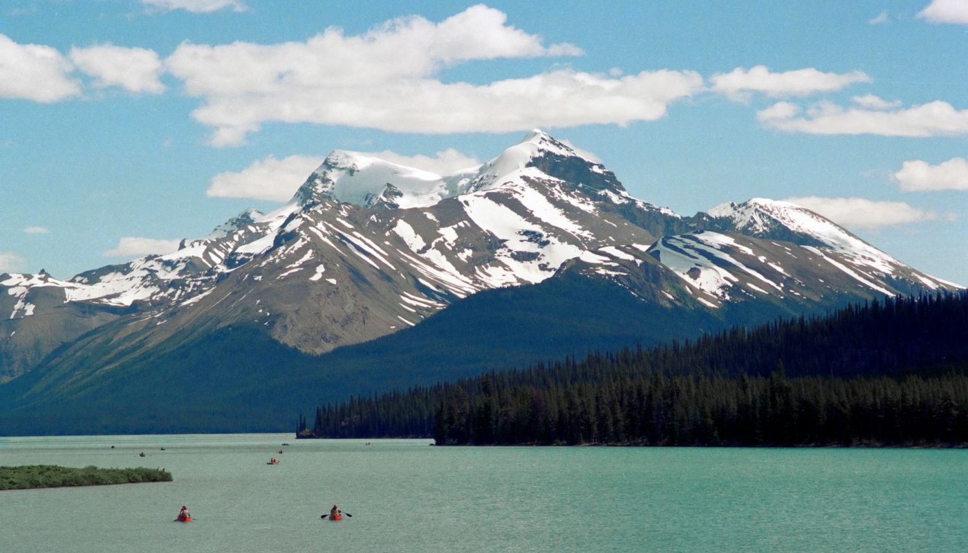 Maligne Lake at dawn on a Canada honeymoon, canoe at the shore in still water
