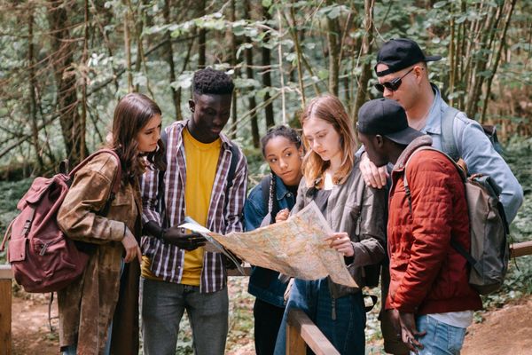 Guide explaining a route on a map with private guests