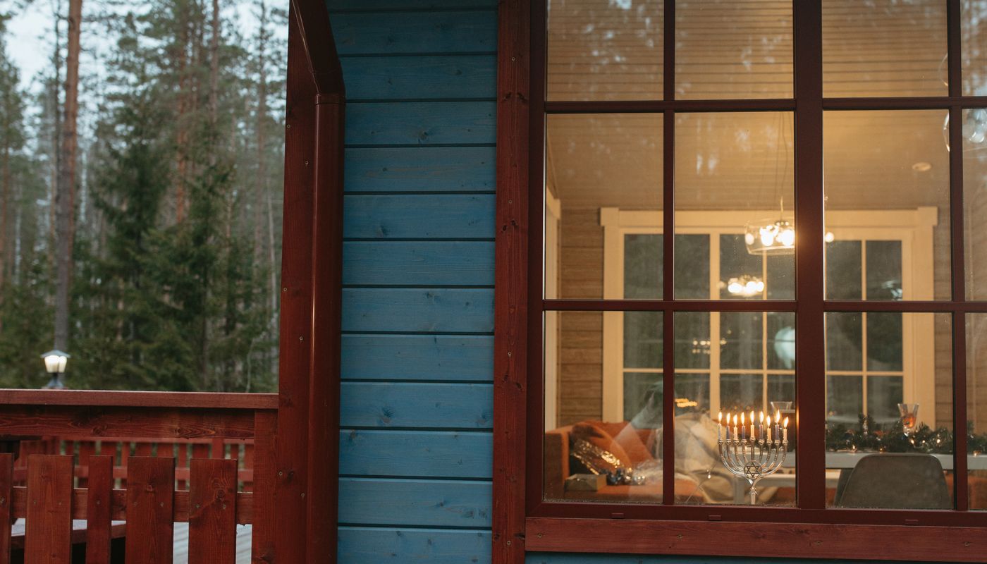 Lodge window in Jasper at dusk with mountains behind